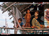 Children play in the water. The Bajau Laut, known as 'the Sea Gypsies,' live at the seaside of Malaysia and the Philippines. They build and live in tatty wooden sheds above the water and make a living by fishing. They have no access to education due to poverty and live on the margins of society.