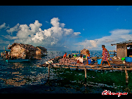  People dry the fish they have caught at the sea. The Bajau Laut, known as 'the Sea Gypsies,' live at the seaside of Malaysia and the Philippines. They build and live in tatty wooden sheds above the water and make a living by fishing. They have no access to education due to poverty and live on the margins of society.