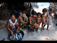 Women and children are left at home after the men went out to the sea. The Bajau Laut, known as 'the Sea Gypsies,' live at the seaside of Malaysia and the Philippines. They build and live in tatty wooden sheds above the water and make a living by fishing. They have no access to education due to poverty and live on the margins of society.
