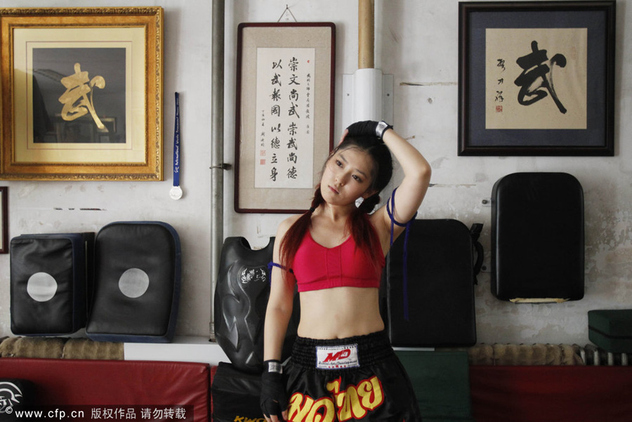 Zhang Peiran is training under the instructions of her coach Cao Anming in a fighting club in Qingdao, east China. The 21-year-old Kungfu fanatic is studying in Britain and practices sanda (sparring) during her summer holidays. 