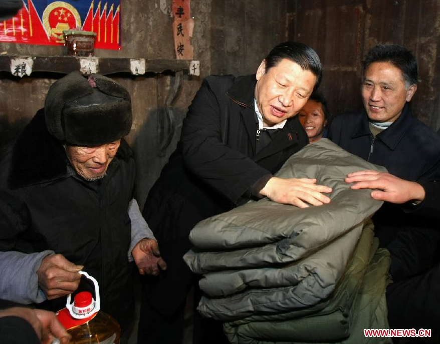 File photo taken in January 2008 shows Xi Jinping (C) visits Tang Zhaowei, a villager of Dong ethnic group who suffered a loss in the snow and ice storms, in Laoshankou Village of Gaolouping Township, southwest China&apos;s Guizhou Province. (Xinhua/Lan Hongguang) 