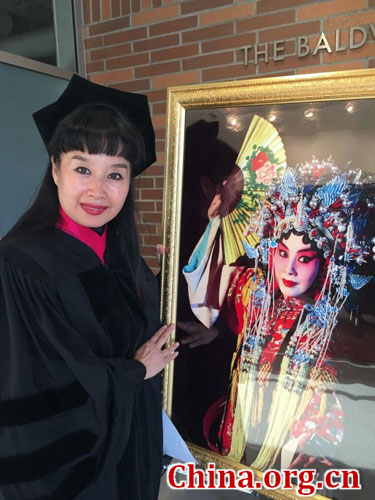 京剧艺术家孙萍在查普曼大学与她的一张带妆照片合影。[中国网]