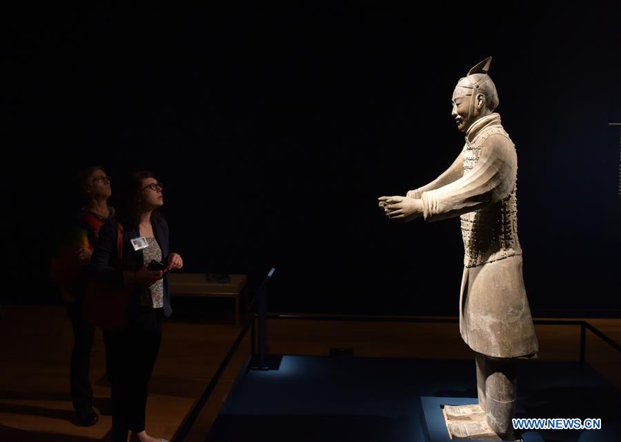 People view a terracotta warrior during a press preview at the Virginia Museum of Fine Arts (VMFA) in Richmond, Virginia, the United States, on Nov. 15, 2017. Titled &apos;Terracotta Army: Legacy of the First Emperor of China,&apos; the exhibition features more than 130 artifacts, including 10 life-size terracotta warriors. The exhibition will be at VMFA from Nov. 18 to March 11, 2018. (Xinhua/Yin Bogu)
