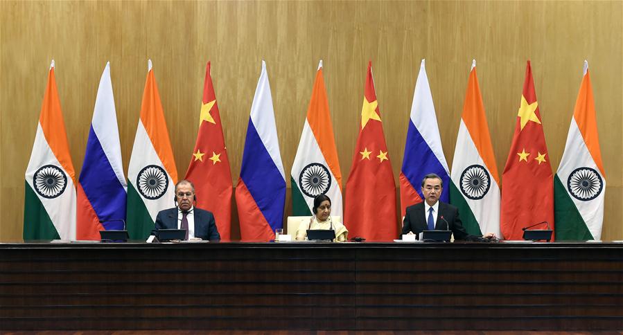 Chinese Foreign Minister Wang Yi (R) addresses a press conference after the 15th trilateral meeting of the foreign ministers of China, Russia and India with his Russian counterpart Sergei Lavrov (L) and Indian counterpart Sushma Swaraj in New Delhi, India, on Dec. 11, 2017. [Photo/Xinhua]