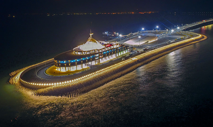 The east man-made island of the Hong Kong-Zhuhai-Macao Bridge is illuminated on Saturday. [Photo/Xinhua]