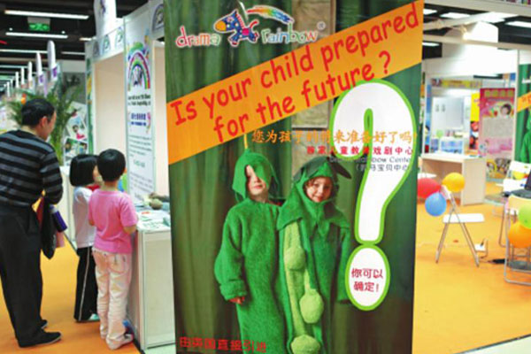 The booth of a drama school for kids, which hires foreign teachers for its courses, at a children's products and education exhibition in Beijing. [Photo/China Daily]