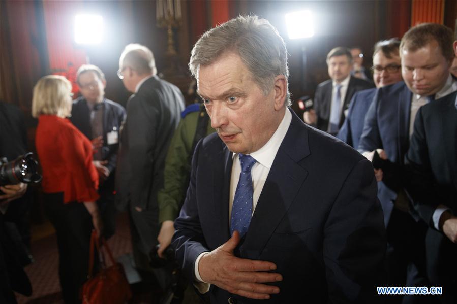 Finnish incumbent President Sauli Niinisto (front) attends a press conference after winning a landslide victory in the presidential election in Helsinki, Finland, on Jan. 28, 2018. 