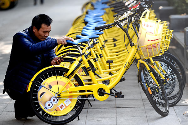 A customer uses an Ofo bike in Luoyang, Henan province.[Photo by Zhang Yixi/for China Daily] 