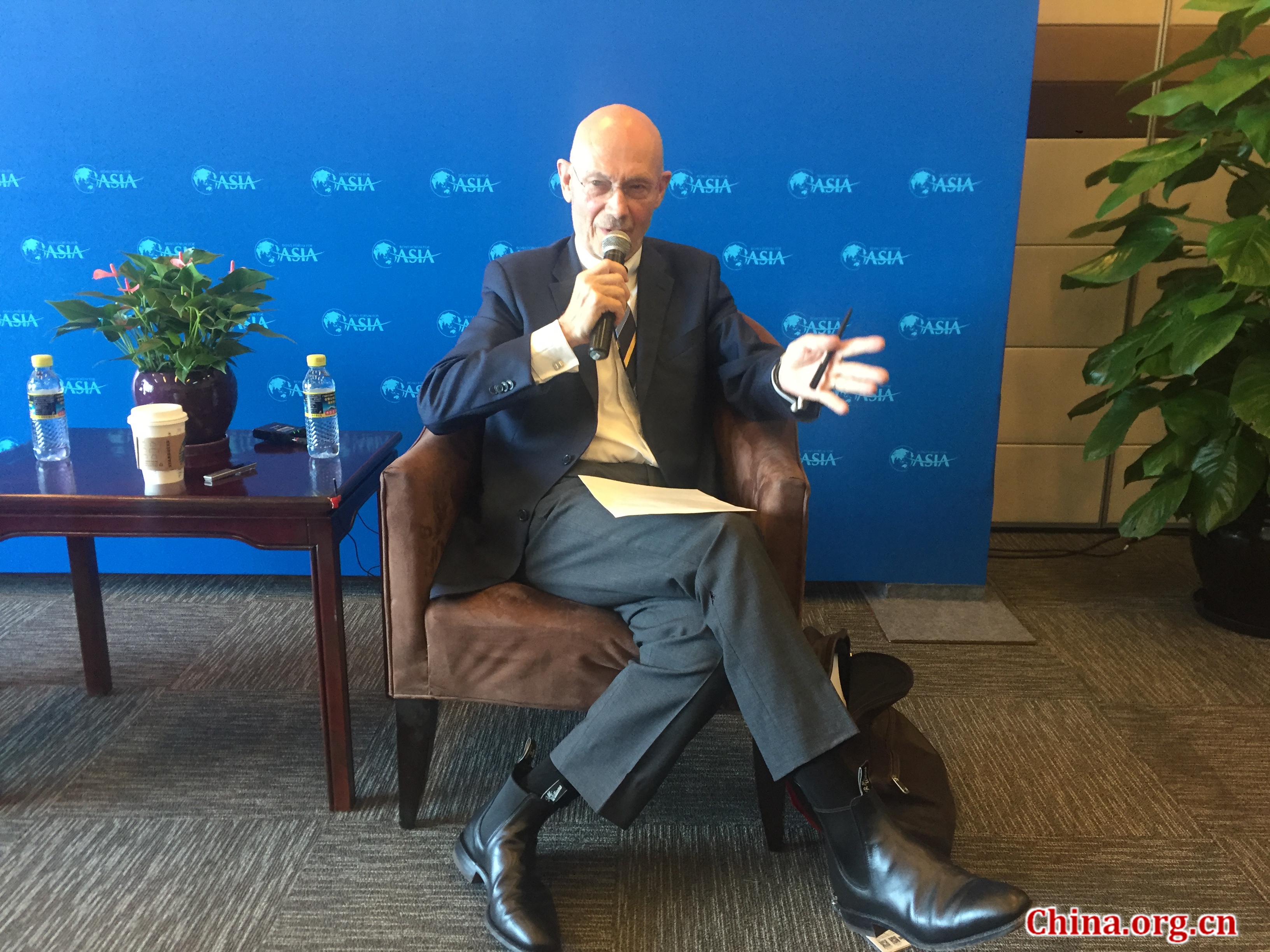 Pascal Lamy, former director-general of the WTO, speaks with media on Wednesday, April 11, 2018 at this year's Boao Forum for Asia. [Photo by Guo Yiming/China.org.cn]