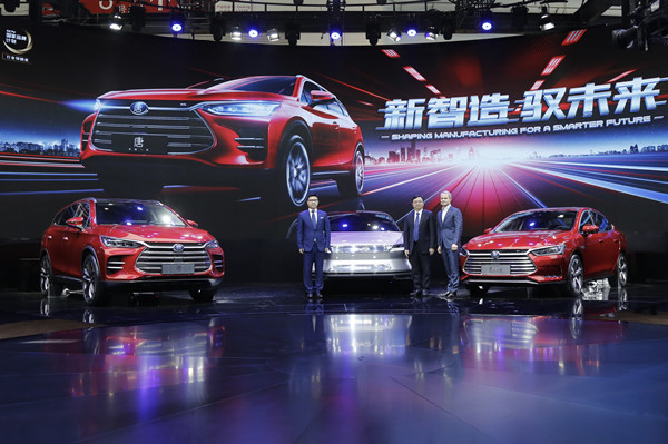 Wang Chuanfu, president and chairman of BYD (middle), Wolfgang Egger, design director of BYD (right), and Zhao Changjiang, general manager of BYD Auto Sales (left) pose for a photo at the 2018 Beijing International Automotive Exhibition, April 25, 2018. [Photo courtesy of BYD]