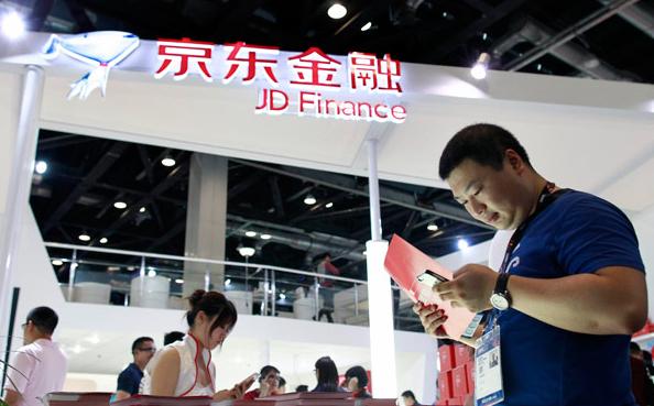 A visitor at the stand of JD Finance at a mobile Internet conference held in Beijing in April 2015. [Photo/China Daily]