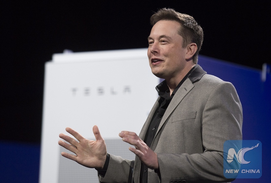 Elon Musk, CEO of Tesla, unveils a suit of batteries for homes, businesses, and utilities at Tesla Design Studio in Hawthorne, California, the United States, April 30, 2015. [Photo/Xinhua]