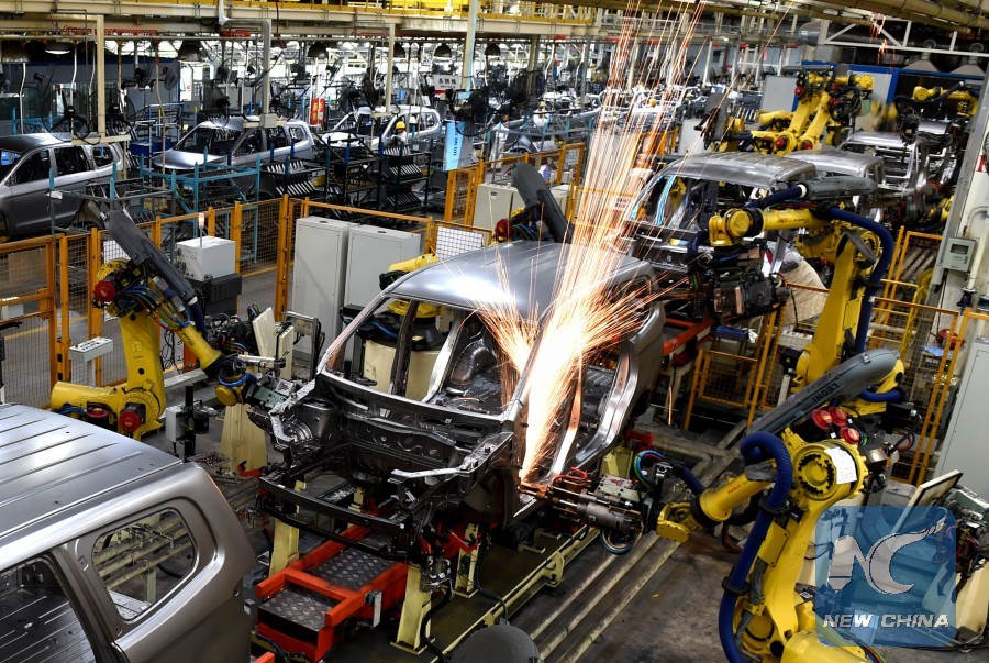 Industrial robots are used for welding vehicle bodies at Liuxin Auto Stamping Co., Ltd. in Liuzhou, southwest China's Guangxi Zhuang Autonomous Region, Nov. 18, 2015.[Photo/Xinhua]