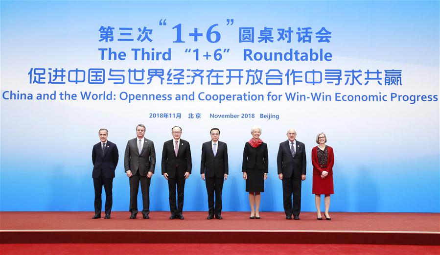 Chinese Premier Li Keqiang (C), together with World Bank Group (WBG) President Jim Yong Kim (3rd L), International Monetary Fund (IMF) Managing Director Christine Lagarde (3rd R), World Trade Organization (WTO) Director-General Roberto Azevedo (2nd L), Organization for Economic Cooperation and Development (OECD) Secretary-General Angel Gurria (2nd R), Financial Stability Board (FSB) Chairman Mark Carney (1st L) and International Labor Organization (ILO) Deputy Director-General Deborah Greenfield (1st R), poses for a group photo before the third "1+6" Roundtable in Beijing, capital of China, on Nov. 6, 2018. (Xinhua