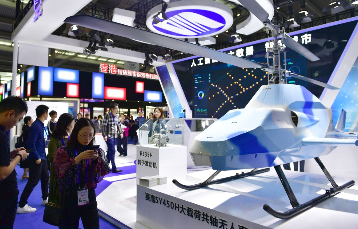 Visitors check out a drone at the China Hi-Tech Fair 2018 in Shenzhen, Guangdong province, on Wednesday. [Photo/China Daily]