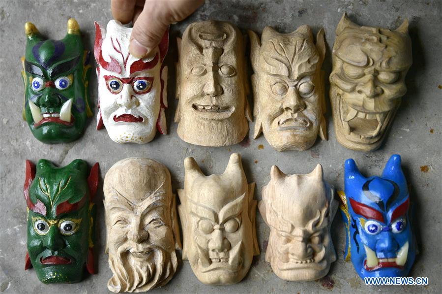 handicraftsman makes masks of nuo opera