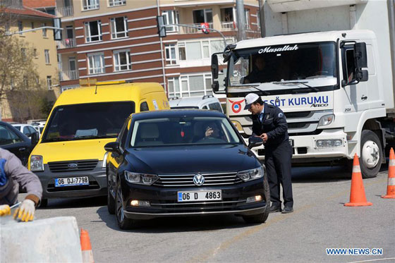 A policeman checks a car in Ankara, Turkey on March 18, 2016. Three ...