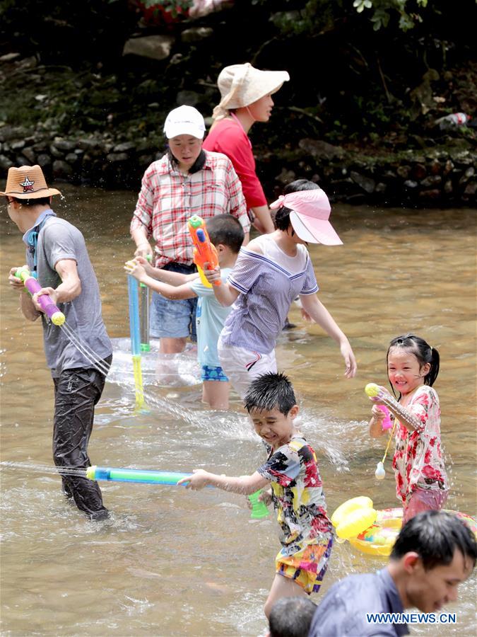 People cool themselves in shallow water at scenic spot in China's ...